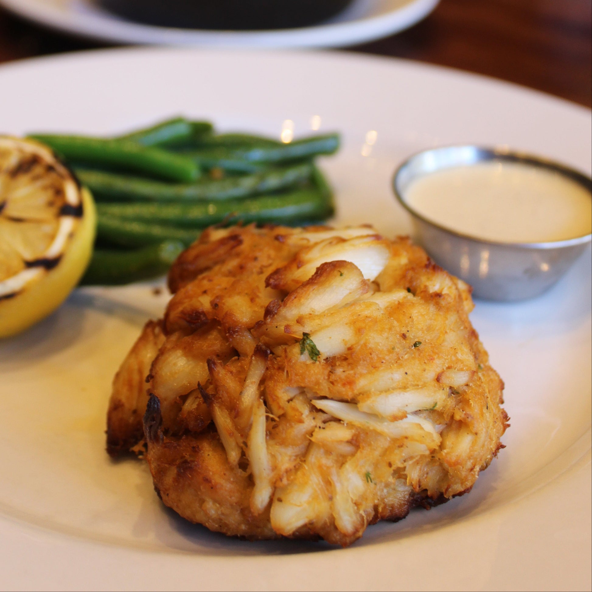 Jumbo Lump Crab Cake with lemon, tartare sauce & sides