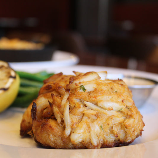 Jumbo Lump Crab Cake on a plate with lemon and tartare sauce